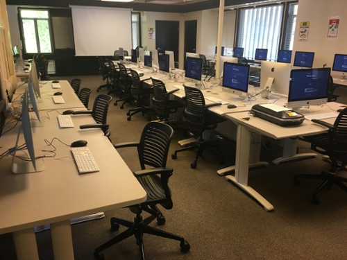 Rows of chairs and mac computers in the crown lab