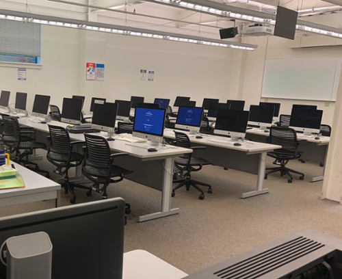 Rows of chairs and computers in the soc sci 1 mac lab